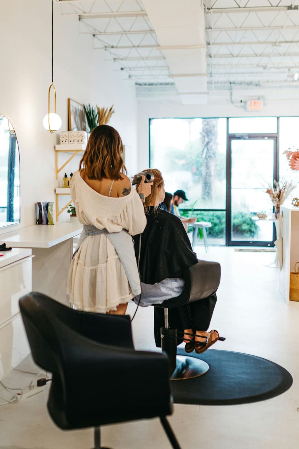 A stylist caring for a customer in a salon